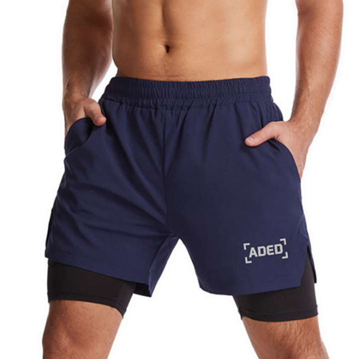 "Andningsbara dubbellager sportshorts för herrar med elastisk passform, praktiska fickor och inbyggda komprimerande tights."