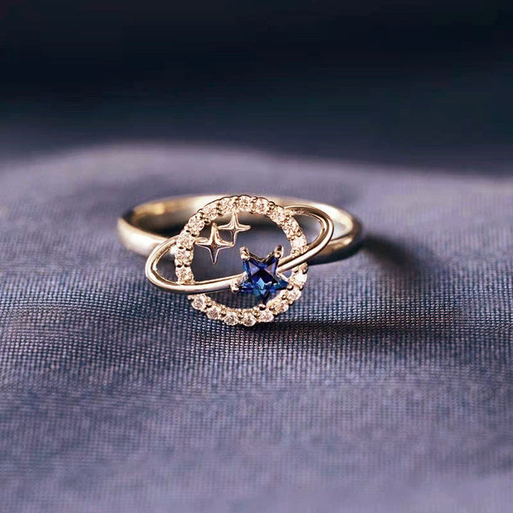 Blå stjärnformade planetariska smycken för kvinnor, med zirkoninlägg, i stål och koppar, elegant och kosmisk design.