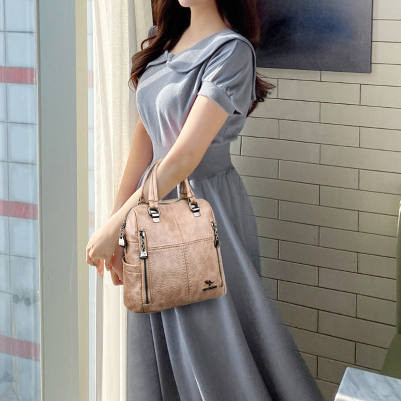 "Damer PU-läder multifunktionell ryggsäck i röd, elegant och slitstark design för vardag och resor, stor kapacitet."