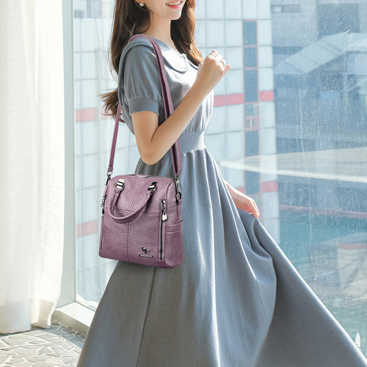 "Damer PU-läder multifunktionell ryggsäck i röd, elegant och slitstark design för vardag och resor, stor kapacitet."