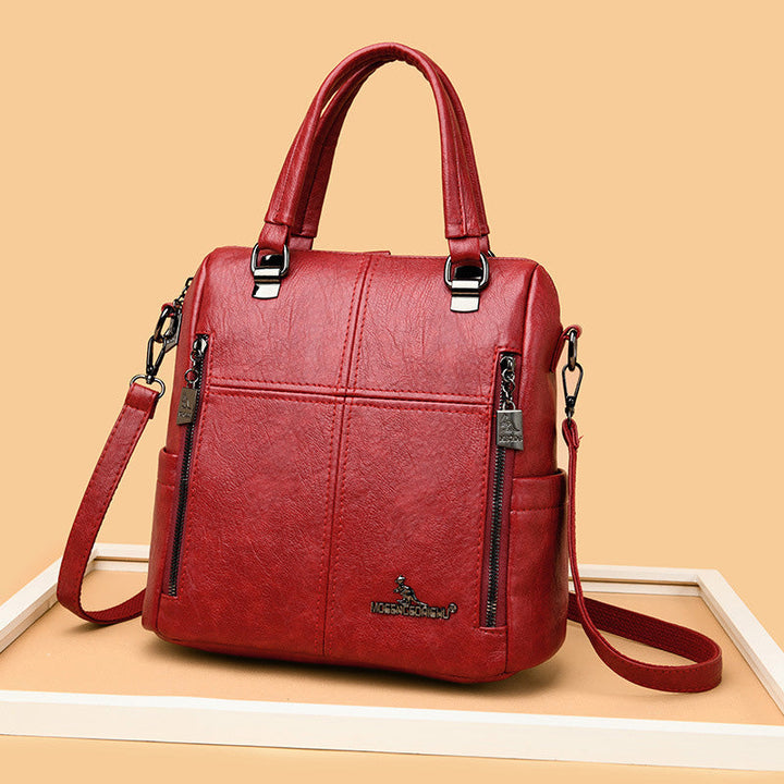 "Damer PU-läder multifunktionell ryggsäck i röd, elegant och slitstark design för vardag och resor, stor kapacitet."