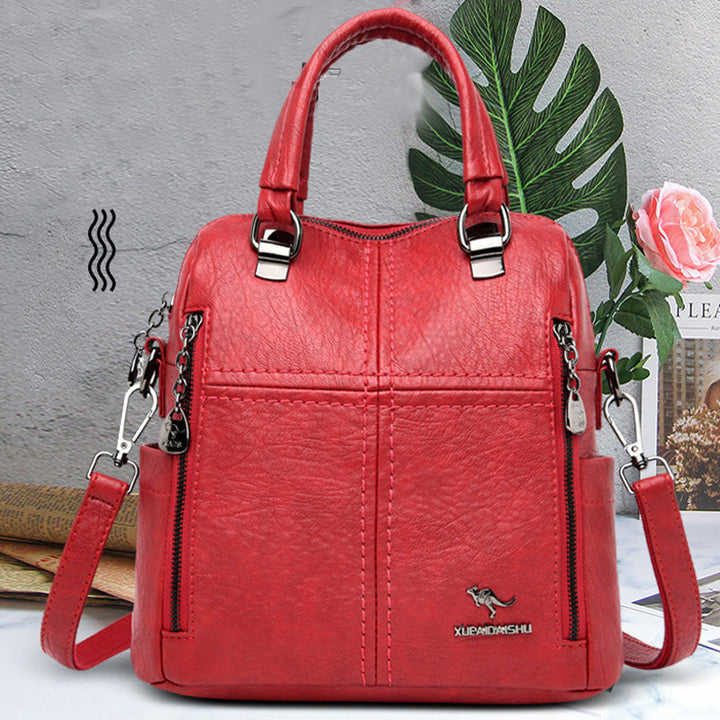 "Damer PU-läder multifunktionell ryggsäck i röd, elegant och slitstark design för vardag och resor, stor kapacitet."