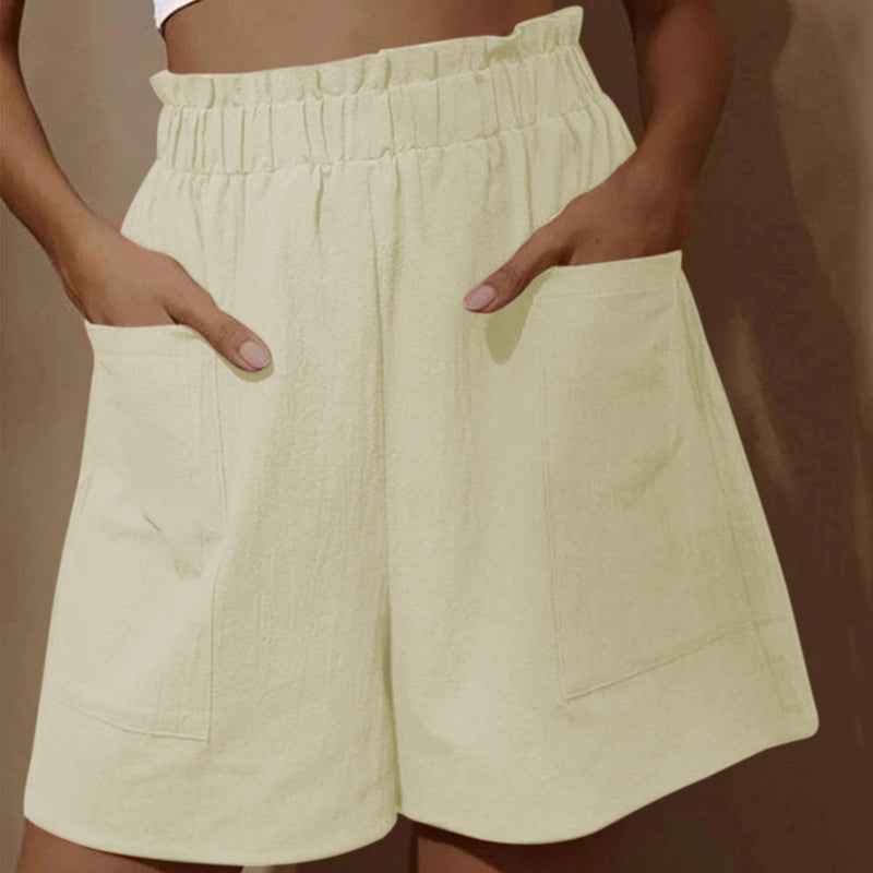 Damshorts med hög midja i bomull, framifrån. Perfekta för sommaren, med justerbar dragsko och två snedställda fickor.