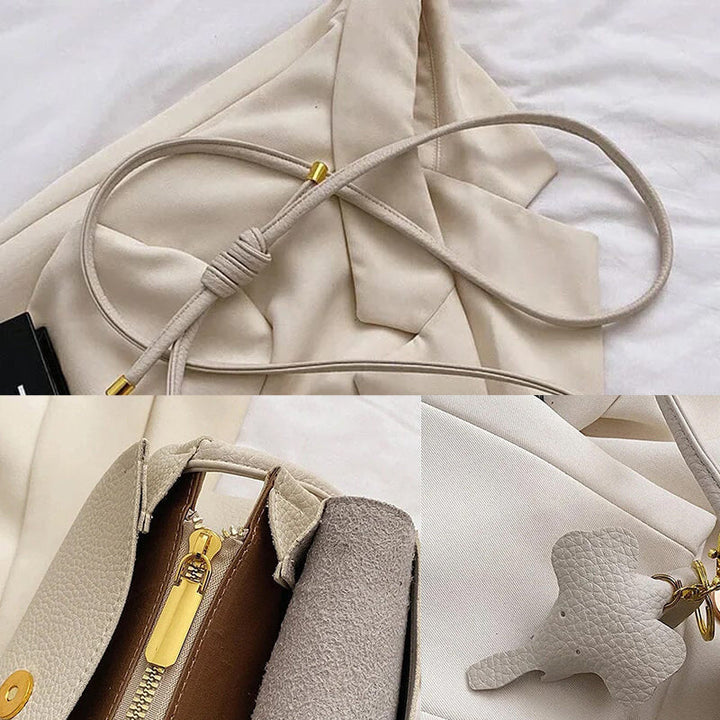 "Elegant crossbody-väska för kvinnor i PU-läder med elefanthänge, säker dragkedja, vit och compact med rymliga fack."