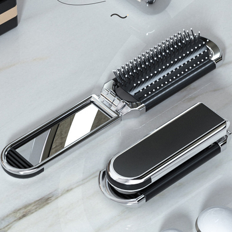 "Elegant resevänlig silver spegelhårborste, unisex design, kompakt och hopfällbar med spegel för enkel stiljustering."