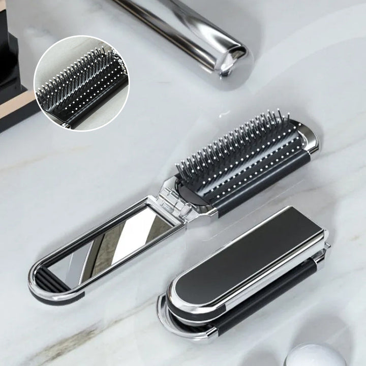 "Elegant resevänlig silver spegelhårborste, unisex design, kompakt och hopfällbar med spegel för enkel stiljustering."