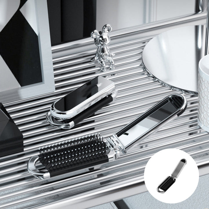 "Elegant resevänlig silver spegelhårborste, unisex design, kompakt och hopfällbar med spegel för enkel stiljustering."