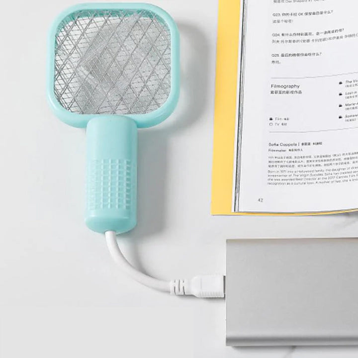 "Elektrisk myggsmällare i svart, vit, rosa, grön för effektiva insektborttagning inomhus/utomhus, stilren design."