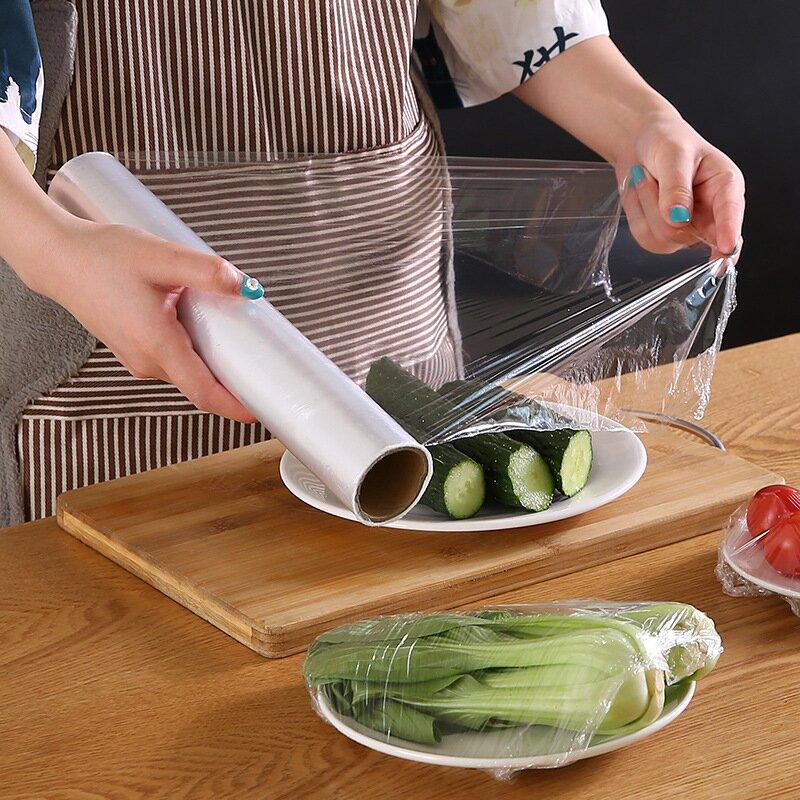 "Ergonomisk plastfolieskärare i vitt med magnetfäste, modern design, skär plast- och aluminiumfolie effektivt."