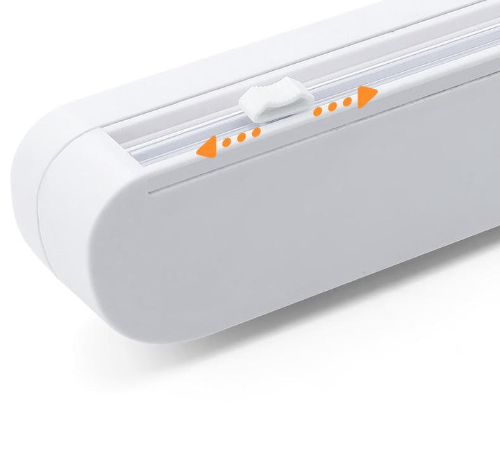 "Ergonomisk plastfolieskärare i vitt med magnetfäste, modern design, skär plast- och aluminiumfolie effektivt."