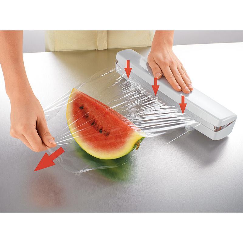 "Ergonomisk plastfolieskärare i vitt med magnetfäste, modern design, skär plast- och aluminiumfolie effektivt."