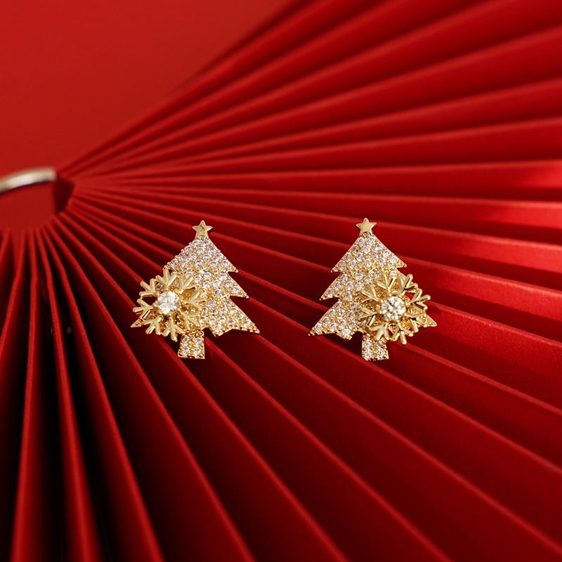 "Festliga julgransformade damörhängen i guld och silver, elegant design och skinande finish för julens högtider."
