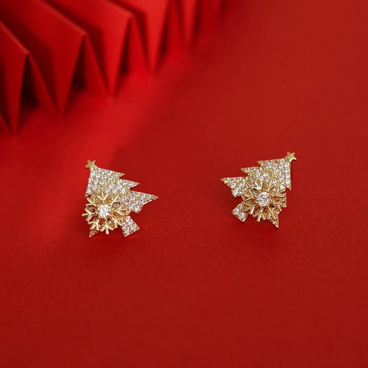 "Festliga julgransformade damörhängen i guld och silver, elegant design och skinande finish för julens högtider."