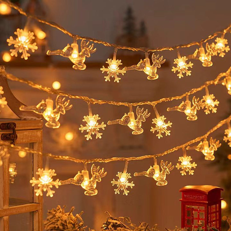 "Förtrollande julsnöre med snöflingor och varm guldljus, perfekt för festlig hemdekor inomhus och skyddad utomhus."