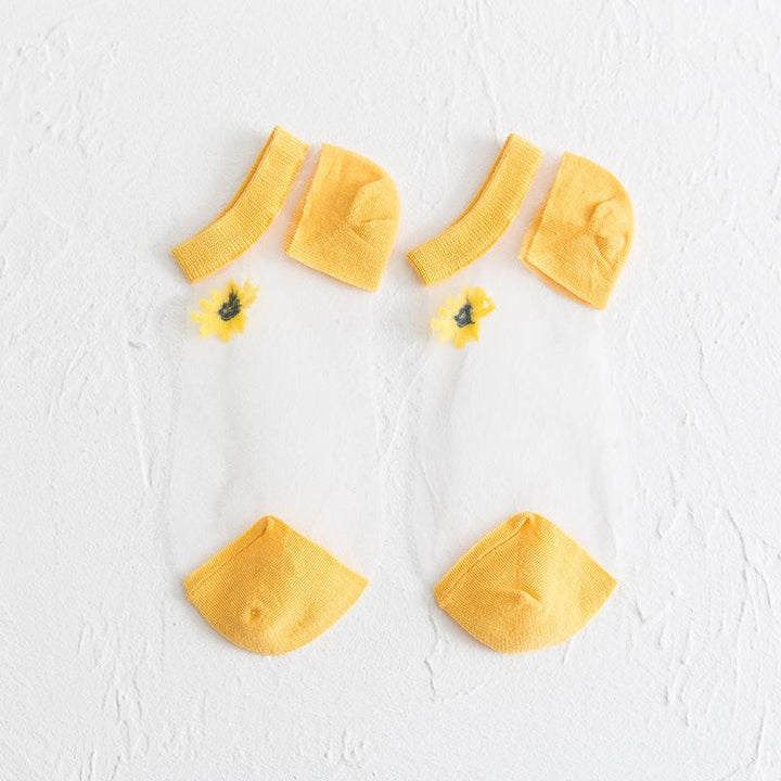 "Genomskinliga damsockor med blommotiv, feminin design med spets- och blomdetaljer, perfekt för sommaroutfits."