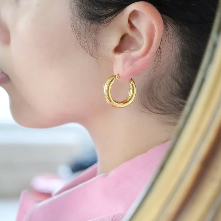 Guldfärgade ringörhängen i rostfritt stål, olika storlekar, elegant look för alla tillfällen och stilpreferenser.