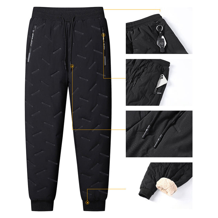"Herr vinterfleece byxor med resårband, platt benöppning, mörk färg, varm fleece, stilren look för kalla dagar."
