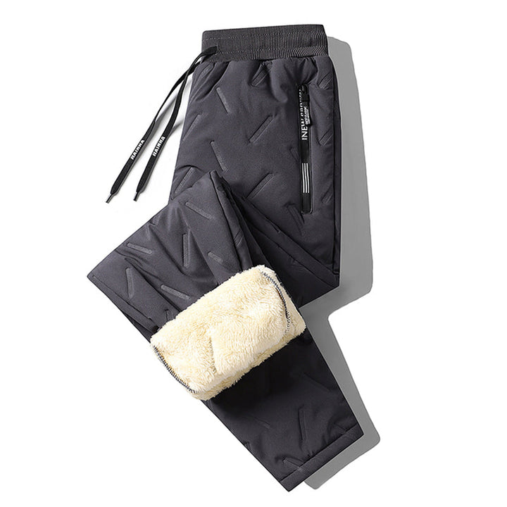 "Herr vinterfleece byxor med resårband, platt benöppning, mörk färg, varm fleece, stilren look för kalla dagar."
