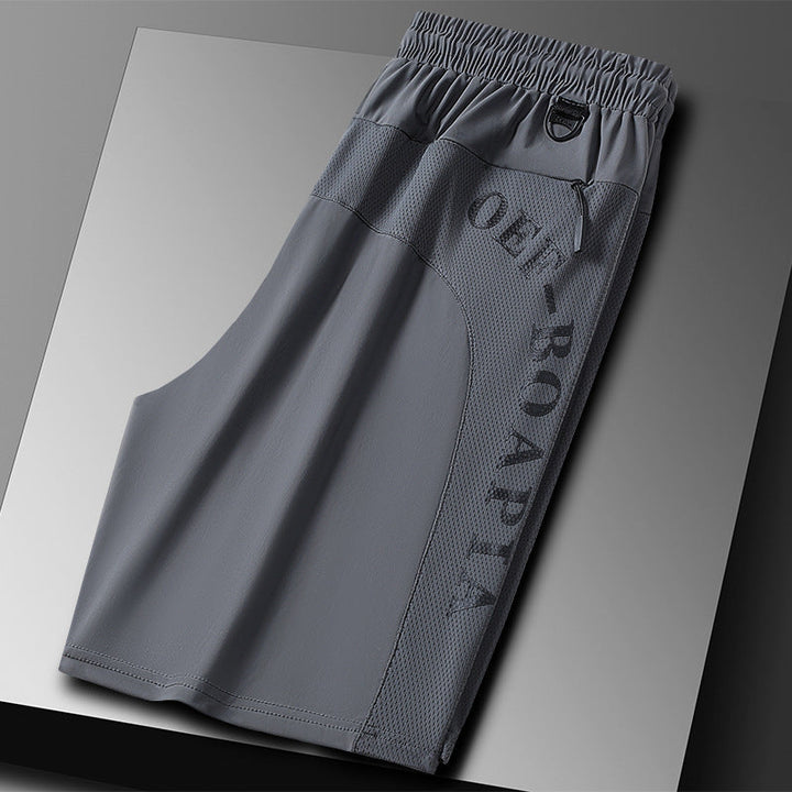 "Herrens sommar stretchiga sportshorts i grått, elastisk midja, praktiska fickor, perfekt för träning och fritid."