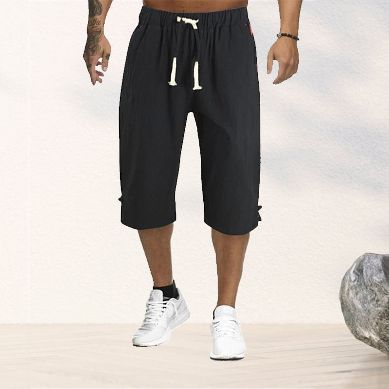 "Herrshorts i beige bomull-linne, dragsko och tre fickor, framifrån i soligt väder"