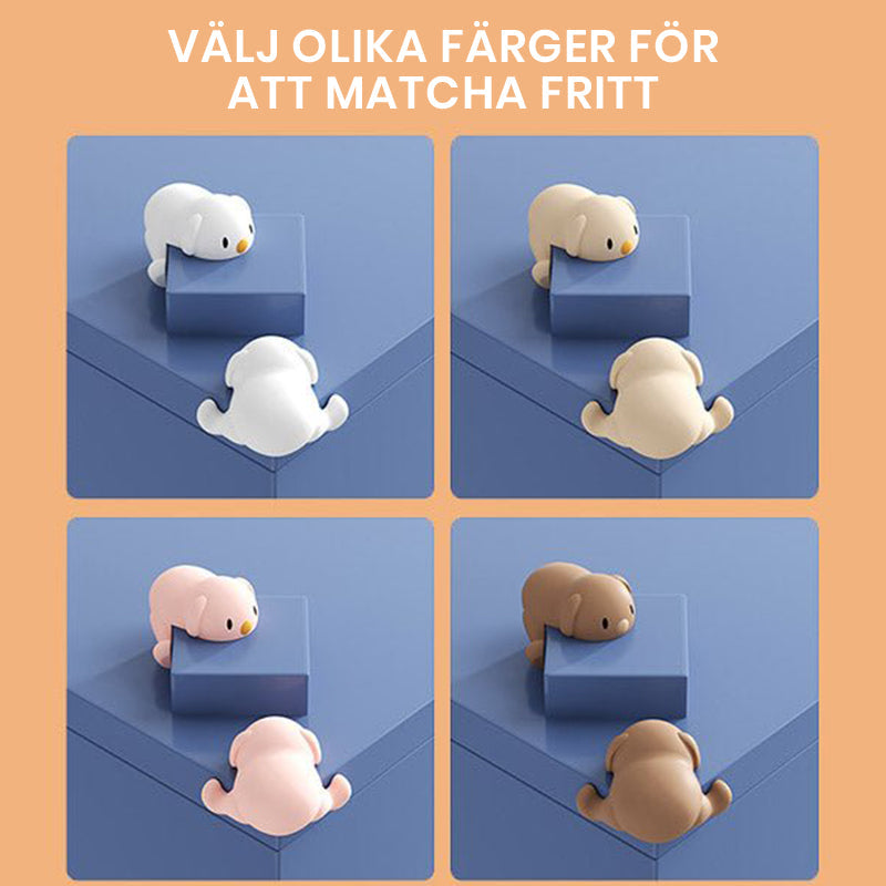 "Hörnskydd i silikon, tecknad design, rosa ton, skyddar barn från skarpa hörn, perfekt för soffbord och stolar."