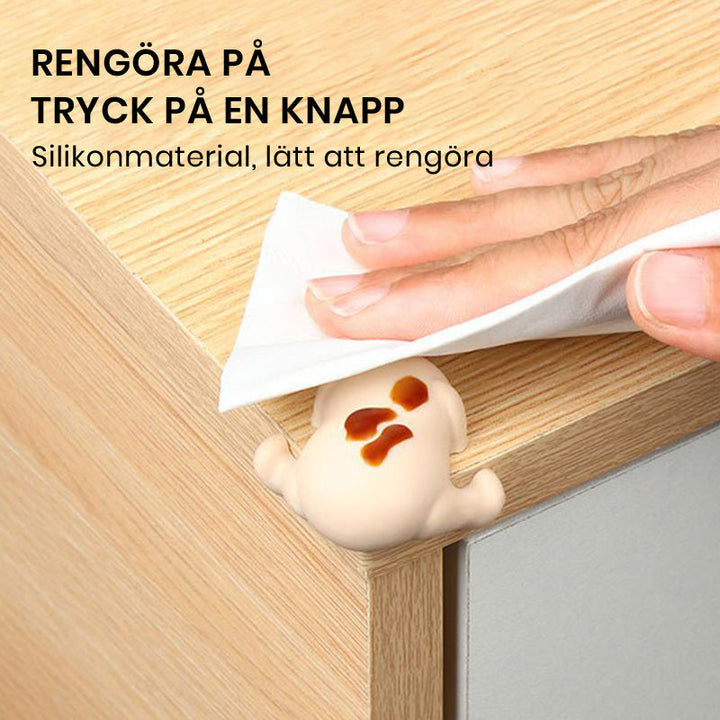 "Hörnskydd i silikon, tecknad design, rosa ton, skyddar barn från skarpa hörn, perfekt för soffbord och stolar."