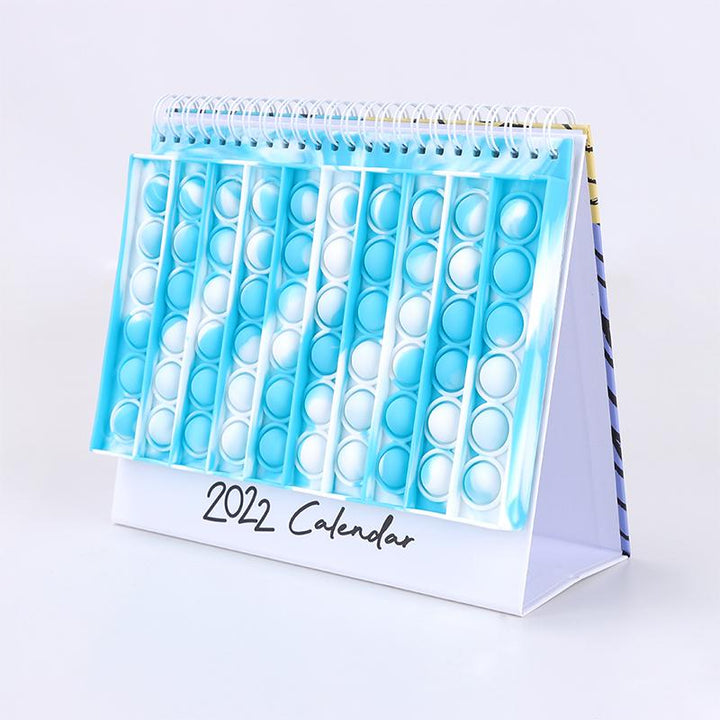 "Kalender med färgglada silikonbubblor för stresslindring och planering, perfekt för hem och kontor, i hållbart material."