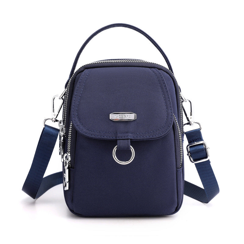 "Lätt vattentät unisex crossbody-väska i nylon med flera fickor, justerbar axelrem, kompakt och funktionell design"