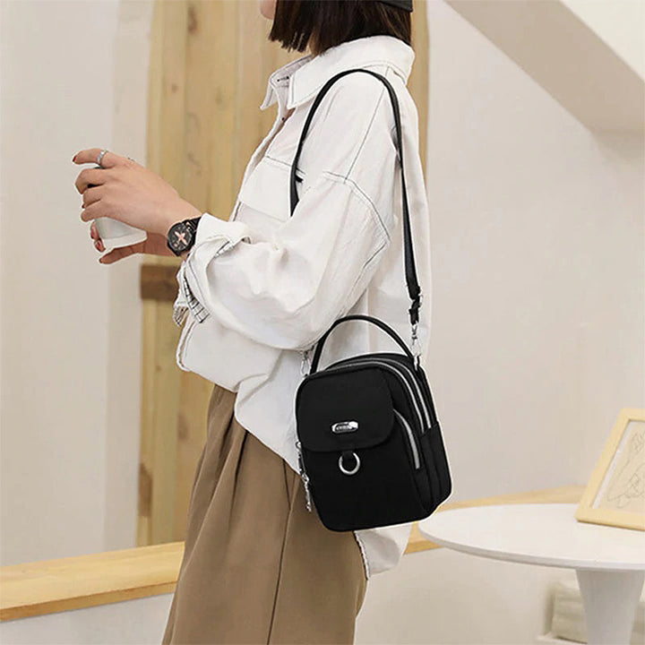 "Lätt vattentät unisex crossbody-väska i nylon med flera fickor, justerbar axelrem, kompakt och funktionell design"