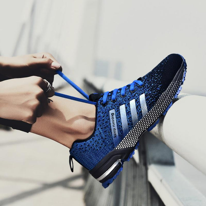 "Löparskor för män i mesh, livliga färgaccenter, halkfri sula, perfekt för jogging och sportaktiviteter."