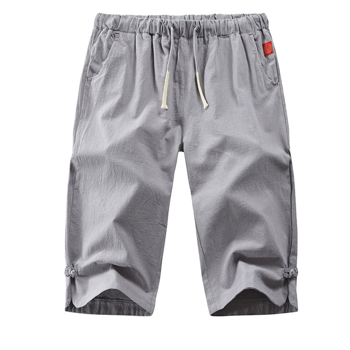 "Mäns sommar linnebyxor med dragsko, sidofickor, i lös haremstil, ljusbeige bomullslinne för vardag och strand."