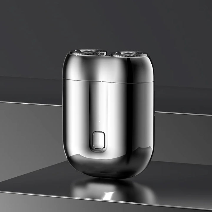 "Mini elektrisk rakapparat för män, bärbar, vattentät, kompakt design med rostfria stålblad och elegant finish."