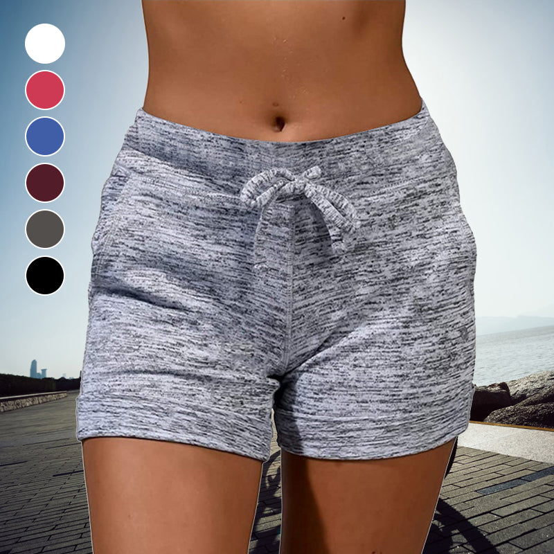 "Snabbtorkande damshorts med mini-längd, elastisk midja och två fickor, perfekt för sommarmode och aktiviteter."