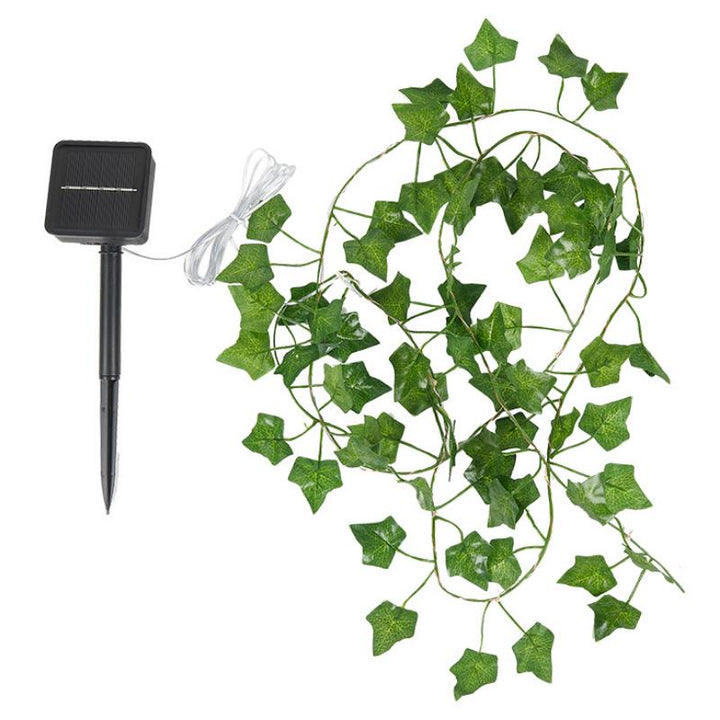 Solcellsdriven dekorativ bordslampa med klätterväxt, glödande LED-ljus, skapar varm och charmig atmosfär i hemmet.