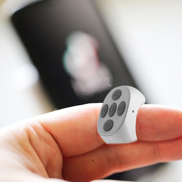 "Trådlös Bluetooth-ringfjärrkontroll för mobil, ergonomisk design, kompakt storlek, finns i svart, rosa, vit."