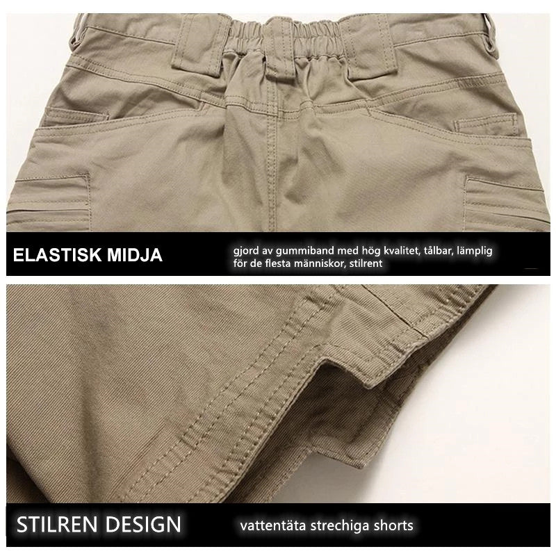 "Vattentåliga herrvandrarshorts med flera fickor, elastiskt midjeband och förstärkt tyg i grön färg, främre vy."