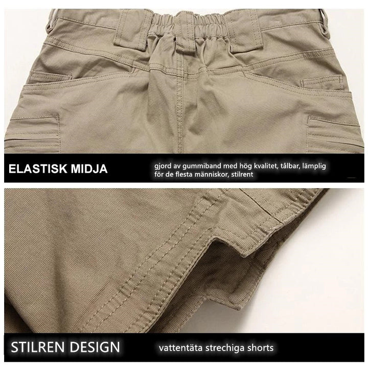 "Vattentåliga herrvandrarshorts med flera fickor, elastiskt midjeband och förstärkt tyg i grön färg, främre vy."