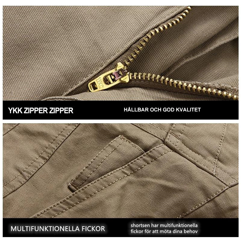 "Vattentåliga herrvandrarshorts med flera fickor, elastiskt midjeband och förstärkt tyg i grön färg, främre vy."