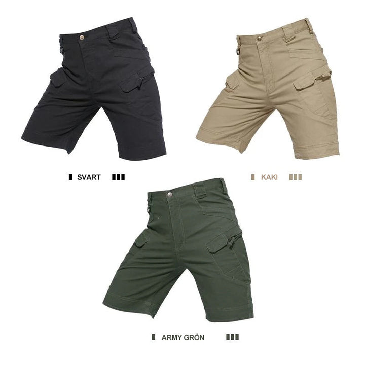 "Vattentåliga herrvandrarshorts med flera fickor, elastiskt midjeband och förstärkt tyg i grön färg, främre vy."